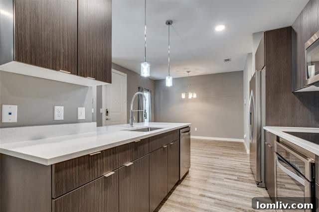 Contemporary kitchen island with pendant lighting and bar seating