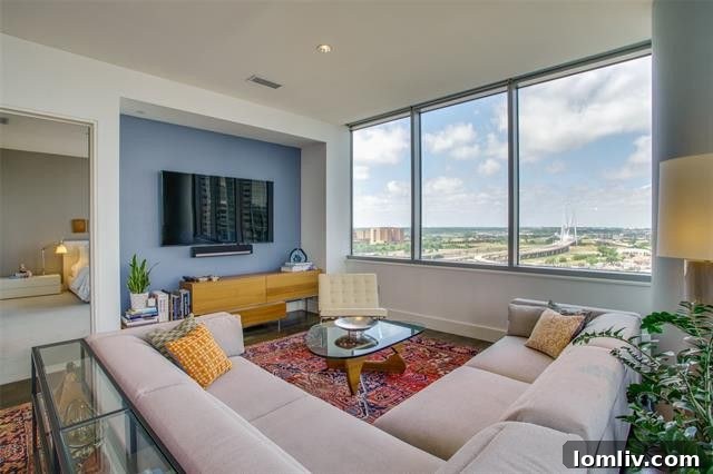 Spacious open-concept living area with rift-cut white oak floors and high ceilings in Unit 1307.