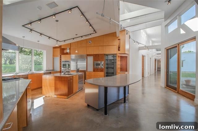 Three Homes From Another Dimension: Limitless Possibilities 10 Modern kitchen with island and sleek cabinetry.