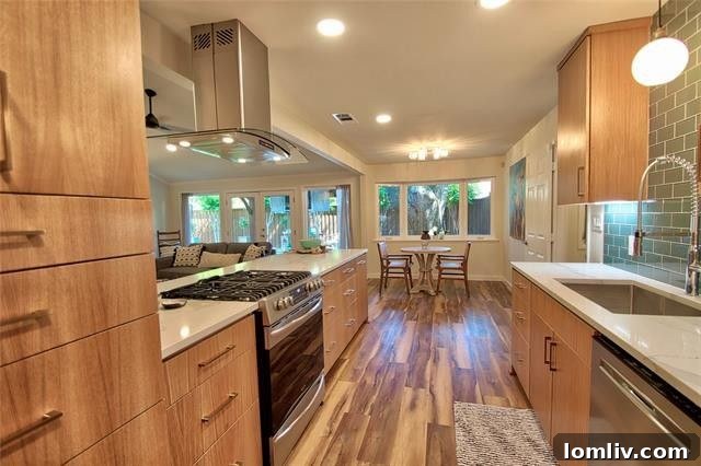 State-of-the-art custom kitchen in Glen Meadow Estates home, showcasing quartz countertops, stainless steel appliances, and designer lighting.