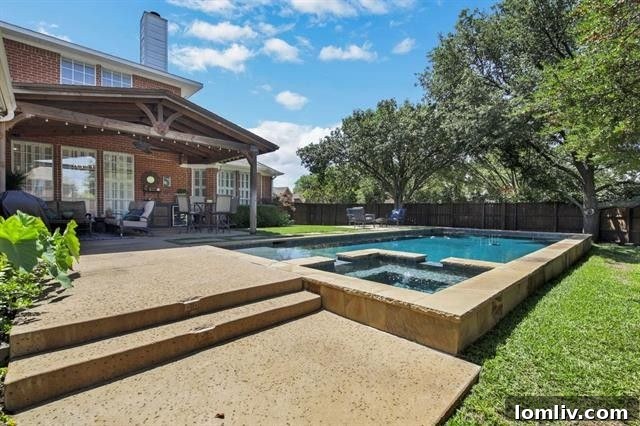 Contemporary pool area with pristine water and modern landscaping in Plano backyard