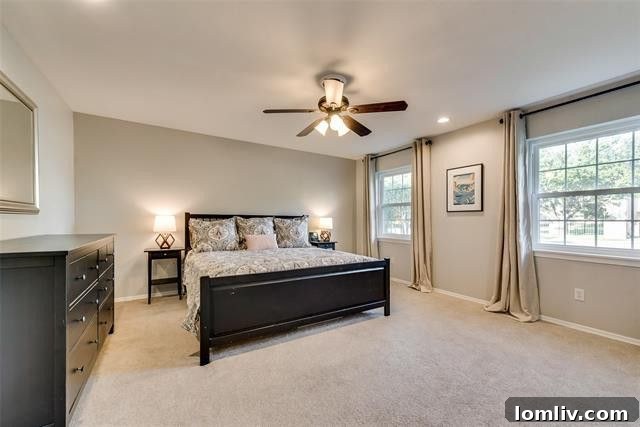 Tranquil master bedroom with neutral decor and hardwood floors on the first floor