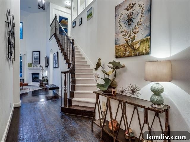 Spacious living area with soaring high ceilings and an elegant fireplace in the custom Forest Hills home