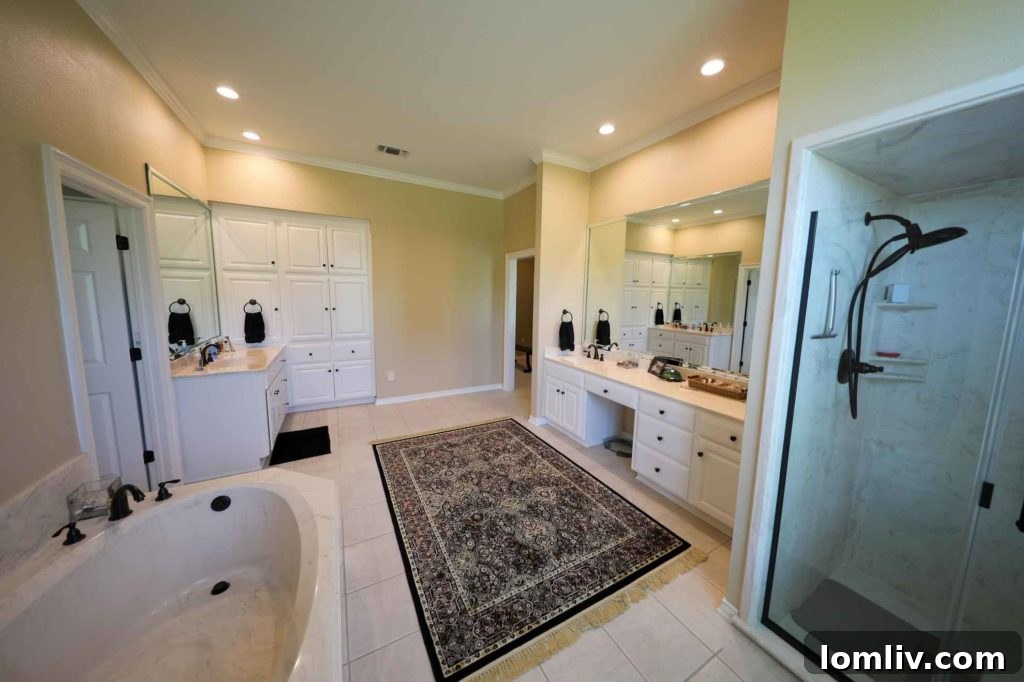 Luxurious master bathroom with dual vanities and soaking tub