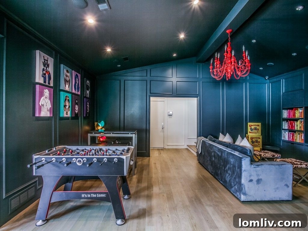 Yeni Medya Odası: Eskimeyen Bir Soluklanma Alanı 9 Lisa Stapp’s vibrant and multi-functional media room, featuring an arcade game, Foosball table, and a unique red chandelier.