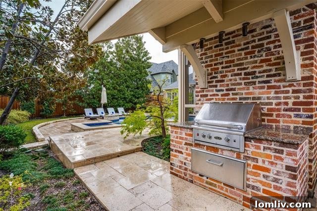 Preston Hollow Mansion: A Beauty Icon's Former Residence 17 Outdoor kitchen and dining area by the pool