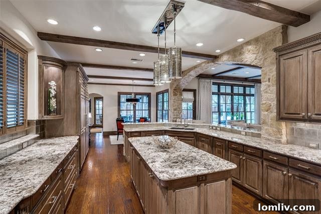Preston Hollow Mansion: A Beauty Icon's Former Residence 8 Chef's dream kitchen featuring SubZero, Wolf, Miele, and Viking appliances