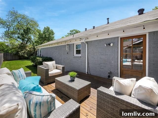 Spacious wooden deck leading to a lush green lawn, perfect for entertaining