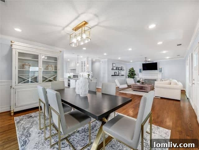 Bright and airy living room with a decorative fireplace and hardwood floors