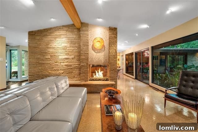 Living area with dramatic see-through stone fireplace