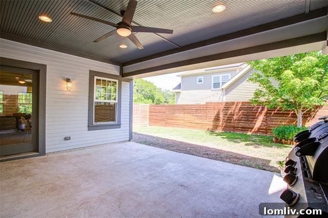 Inviting covered patio overlooking a lush green lawn, perfect for outdoor entertaining