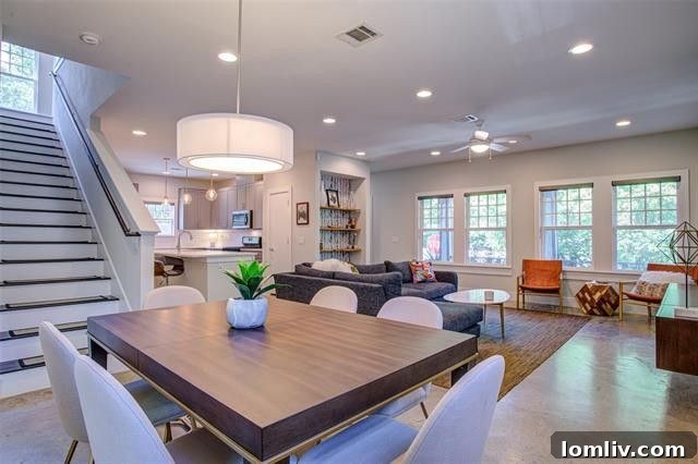 Spacious, light-filled open plan living room with large windows and built-ins