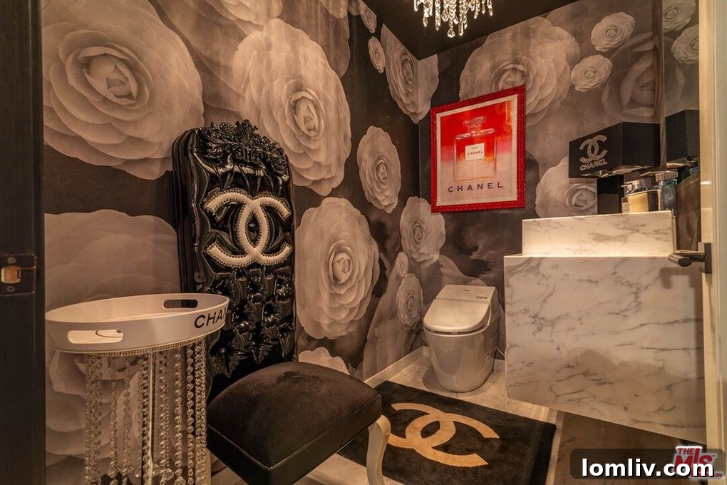 A secondary bedroom in the condo, maintaining the pink and gold theme with branded elements