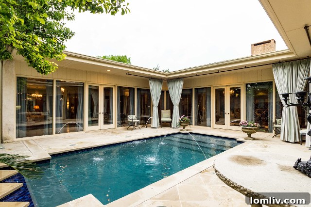 Unique home at 5244 Bryce Avenue built around a central courtyard pool, creating an integrated living experience.