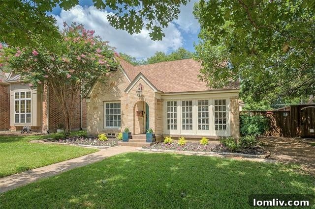 Albany Shaw's Insider Scoop on This Lakewood Hills Tudor Gem 3 Elegant living room with brick fireplace and hardwood floors in Lakewood Hills Tudor