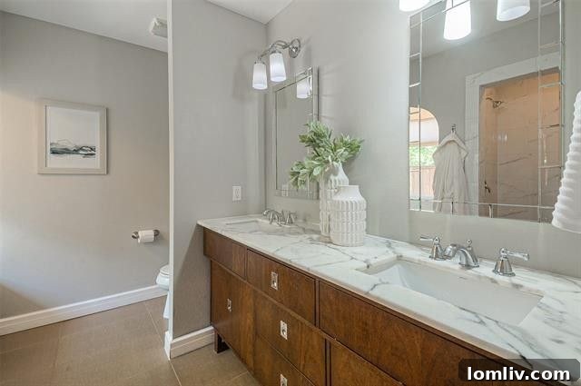 Albany Shaw's Insider Scoop on This Lakewood Hills Tudor Gem 9 Spa-like en-suite bathroom with marble vanity and elegant fixtures