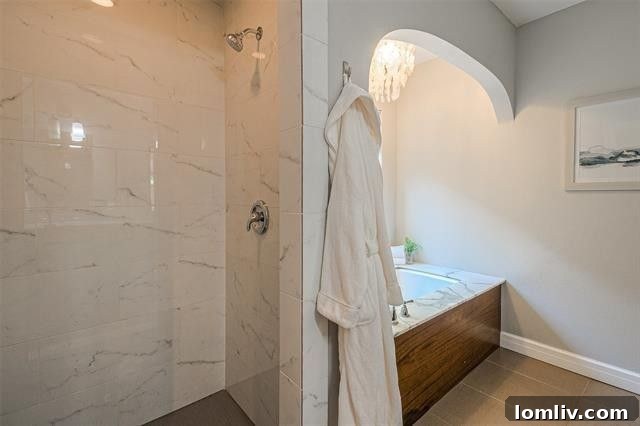 Albany Shaw's Insider Scoop on This Lakewood Hills Tudor Gem 10 Deep soaking tub with luxurious marble surrounds in an en-suite bathroom