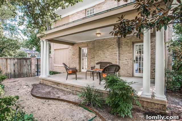 Peaceful side porch offering a private oasis in a historic Swiss Avenue home in Dallas.
