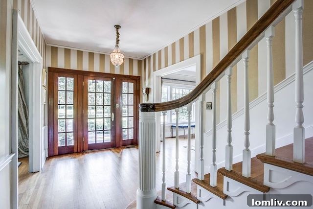 Exquisite entryway and staircase in a historic Swiss Avenue home, highlighting period details and classic design.