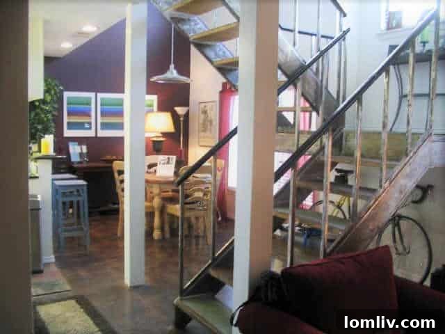 The condo's interior in 2005, highlighting the galvanized steel staircase and plum accent wall