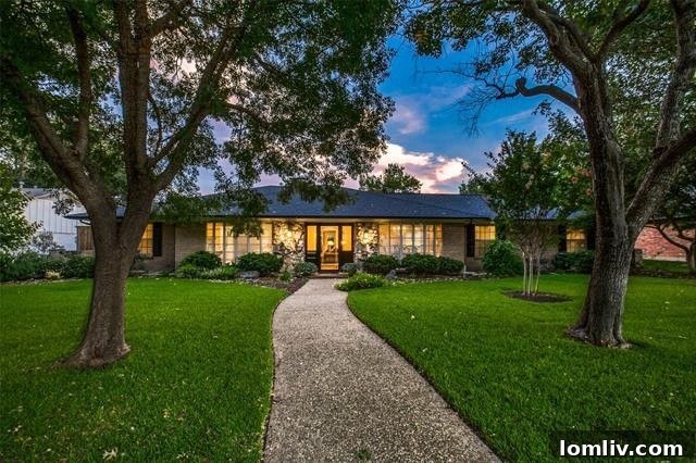 Expansive travertine patio with a large pergola and outdoor kitchen at 4246 Laren Lane, Northwest Dallas