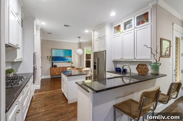 Inviting living room with a cozy fireplace and large windows that fill the space with natural light, showcasing tasteful decor and ample room for relaxation.