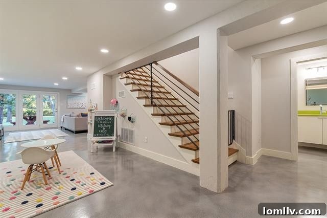 Where Midcentury Modernism Meets Treehouse Wonder 17 A spacious and versatile basement area, featuring natural light and direct outdoor access, perfect for various activities.