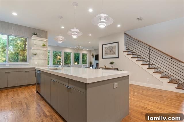 Where Midcentury Modernism Meets Treehouse Wonder 9 A modern kitchen with clean lines, high-end appliances, and elegant cabinetry, reflecting the home's updated style.