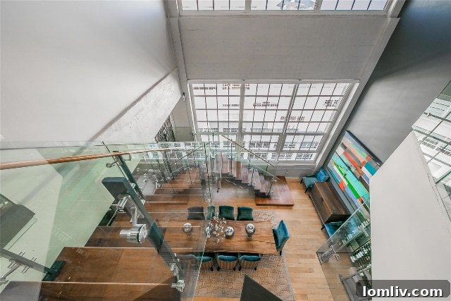 Contemporary glass staircase serving as a stunning focal point within the elegant interior of unit #2824