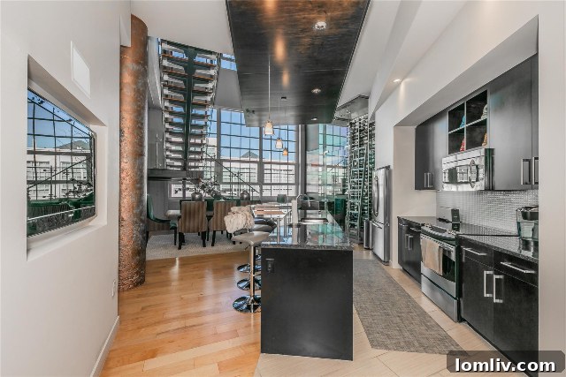 Spacious kitchen integrated into the open-concept floor plan of a luxury condominium