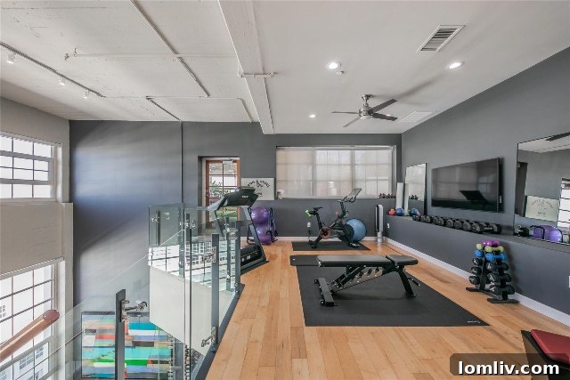 Luxurious media room, private exercise space, and expansive patio within an upscale condo, offering supreme comfort and amenities
