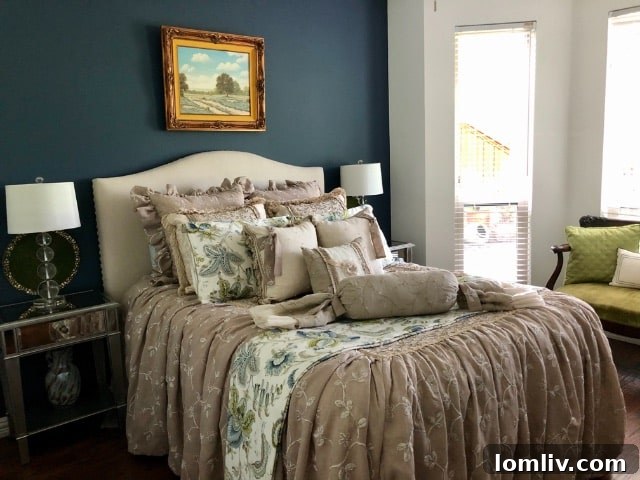 A transformed bedroom featuring a deep navy accent wall behind the bed, beautifully contrasted with white on adjacent walls.