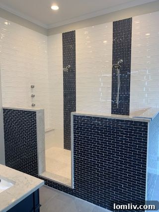 A principal bathroom redesigned with monochromatic tile and neutral paint, creating a sleek, sellable look.