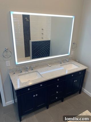 A closer look at the stunning monochromatic tile and neutral paint in the principal bathroom, highlighting modern design.