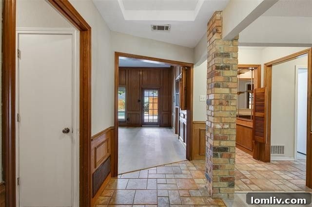 Spacious living room in Carrollton home featuring a brick fireplace