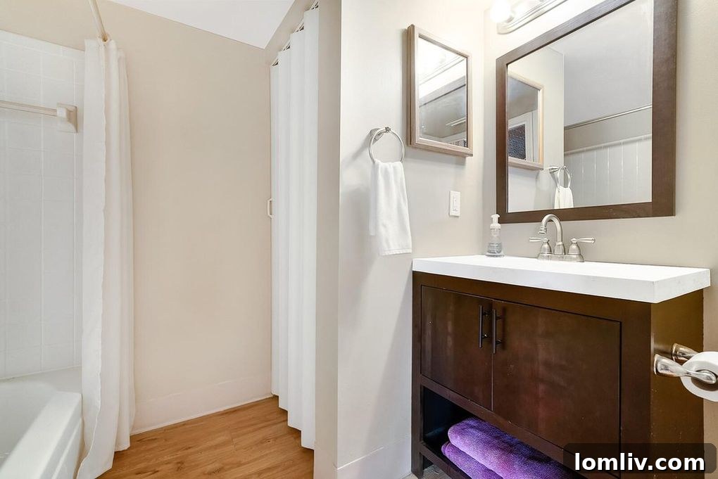 View of a hallway with Budweiser beer can decor leading towards a bathroom