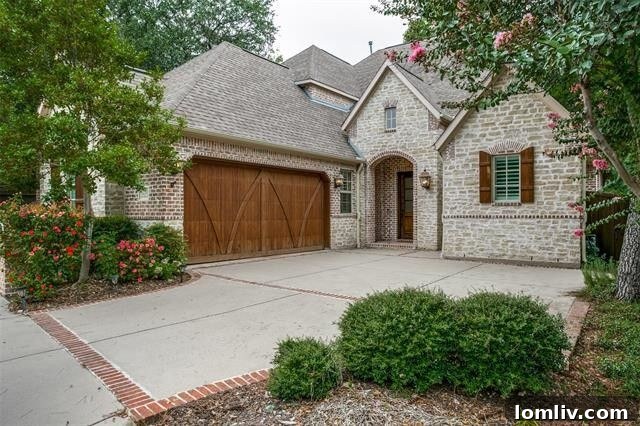 Picturesque stone cottage exterior at 6251 Twin Oaks Circle in Dallas