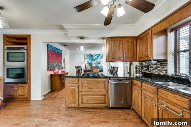 Remodeled kitchen with glass-tiled backsplash and granite countertops at 10316 Linkwood Drive