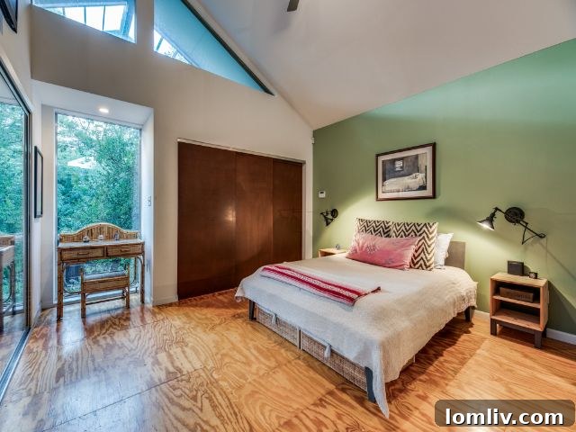 Upstairs bedroom with clerestory windows at 8643 Groveland Drive, evoking a midcentury modern aesthetic.