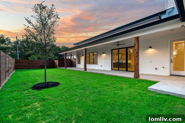 Spacious backyard of a modern ICF home in Dallas, featuring a large covered porch perfect for outdoor living