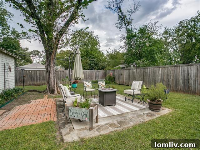 Spacious fenced backyard with patio and mature trees