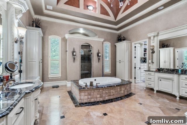 Luxurious master bathroom with deep soaking tub, separate shower, and dual vanities in a Southlake estate