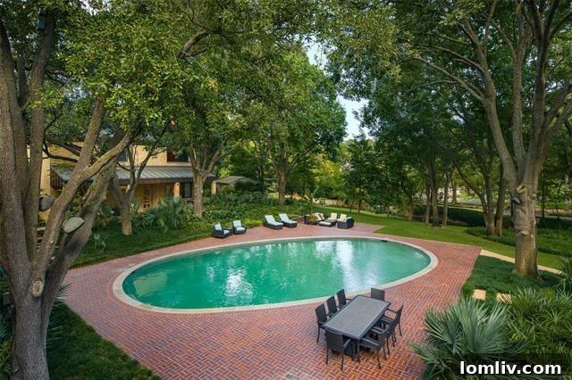 Exterior view of the main residence, showcasing its classic Texas Modern lines and connection to nature.