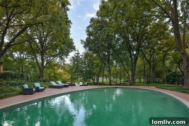 Lush landscaping and pristine grounds surround the luxury estate at 10240 Gaywood Road.