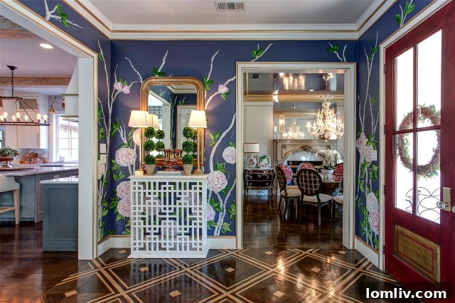 Elegant entry hall with gold accent trim on walls and doors
