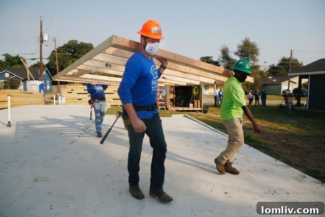 Photo credit for the Habitat for Humanity construction project, highlighting the professionalism and dedication captured by Michael Ainsworth.