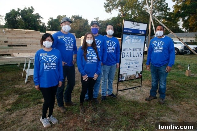 The first shift of the Park Place Motorcars Dallas team, showcasing their enthusiastic volunteers ready to build the Habitat for Humanity home.