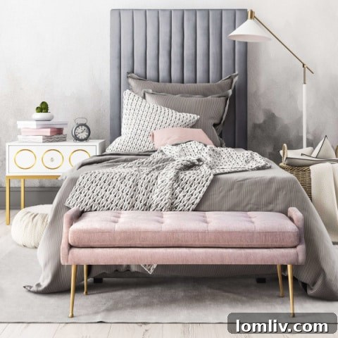Pink Velvet Bench at the Foot of a Bed in a Neutral Bedroom