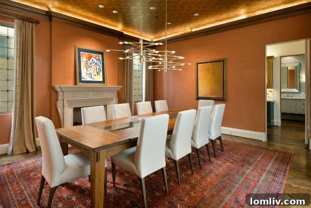 Gourmet kitchen featuring a large central island, high-end appliances, and elegant custom cabinetry