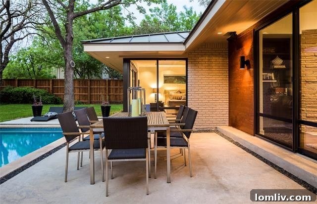 The serene backyard featuring an outdoor fireplace and carefully designed landscaping.